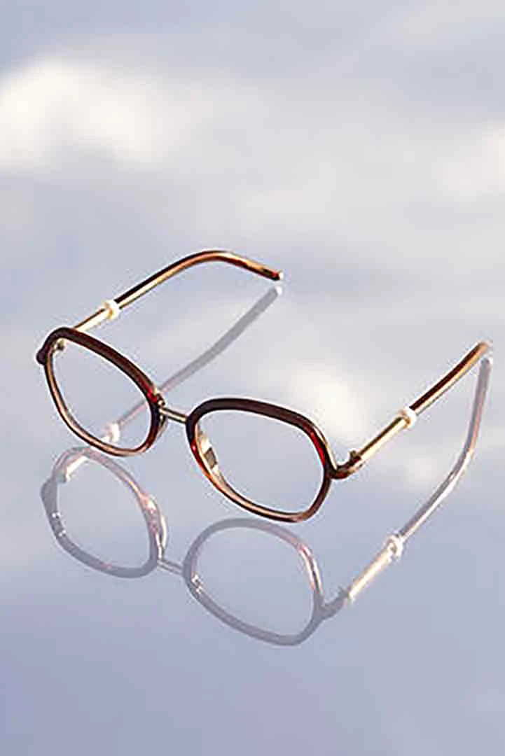 A pair of glasses sitting on top of a table
