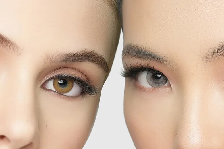A close up of two women wearing brown and clear contact lens