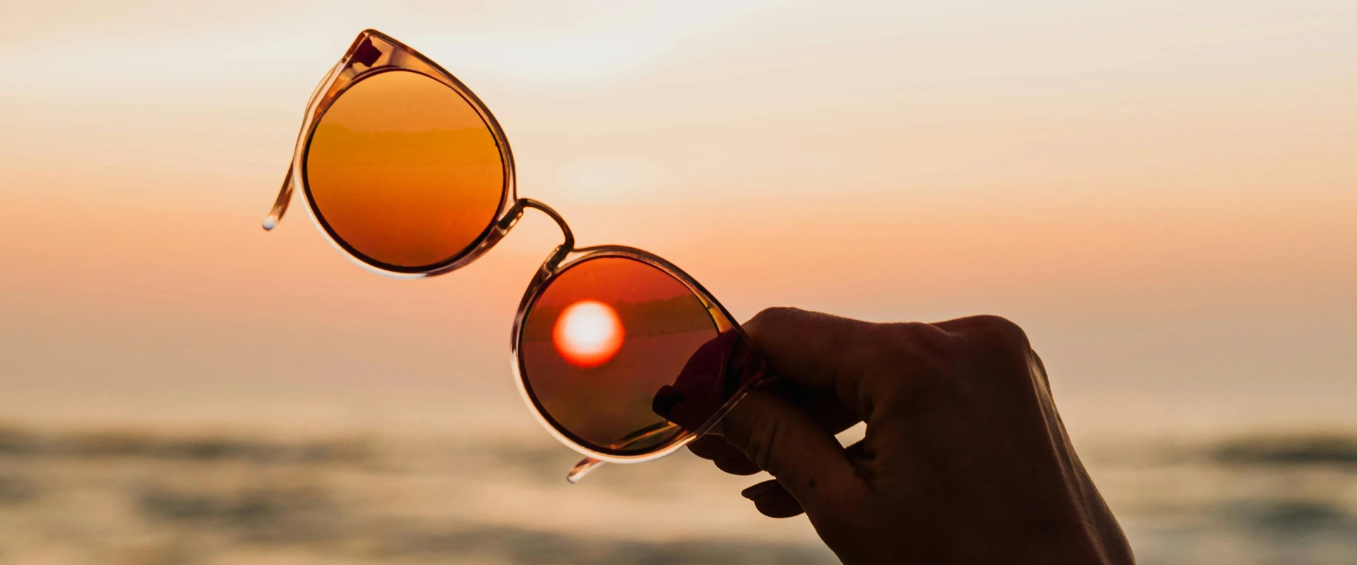 Sunglasses with the sunset in the background.